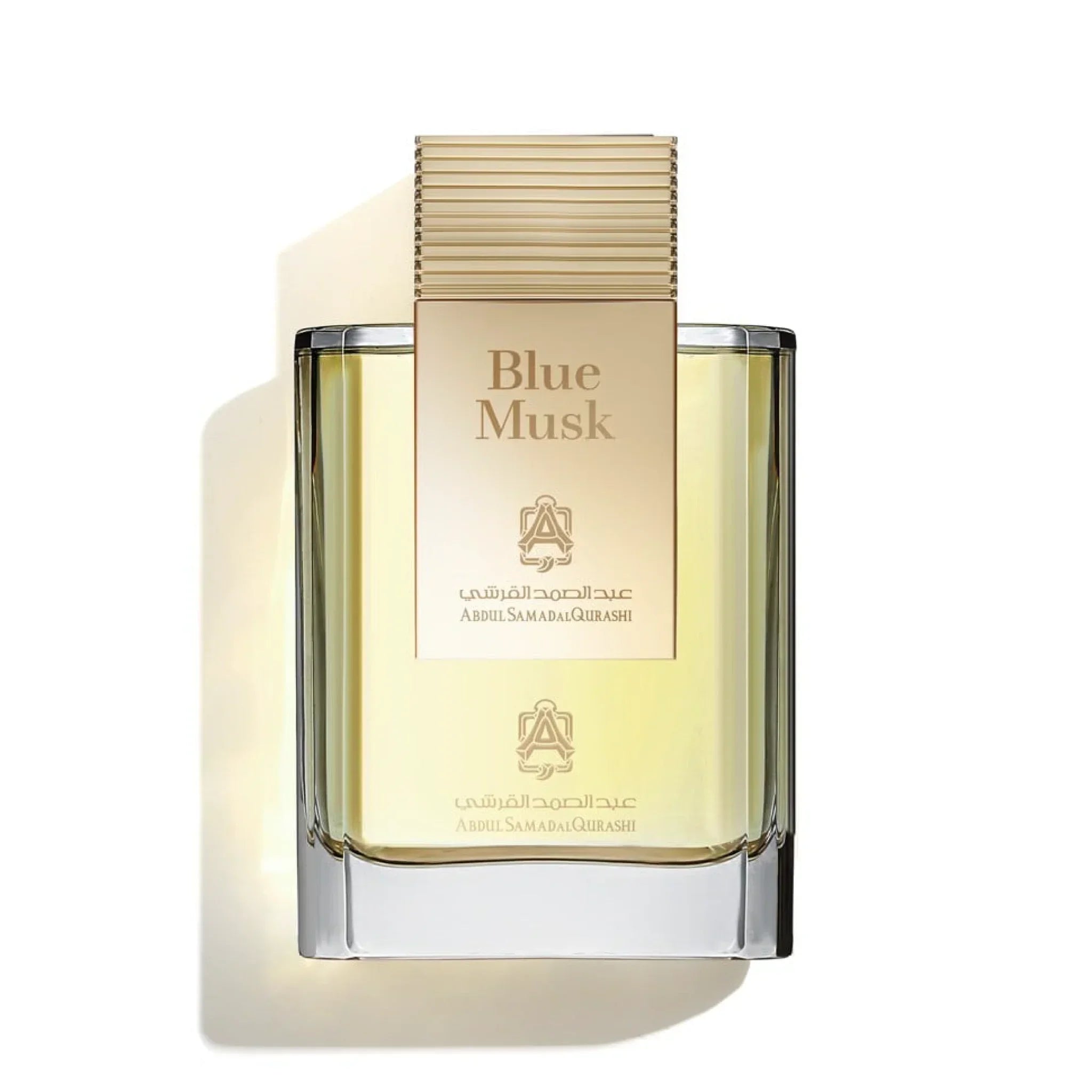 Blue Musk perfume bottle with clear glass and gold label on a white background