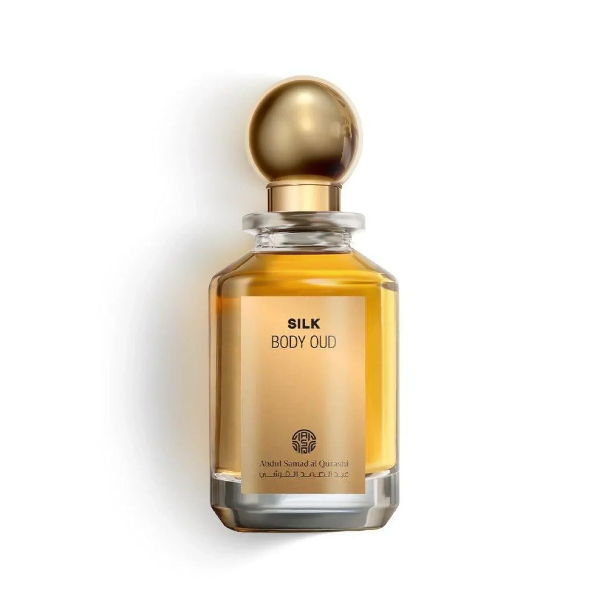 Silk Body Oud perfume bottle with gold cap and amber liquid on a white background