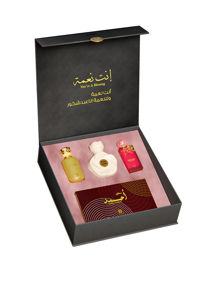 Luxury Middle Eastern perfume gift set with three bottles and a card in a black box.