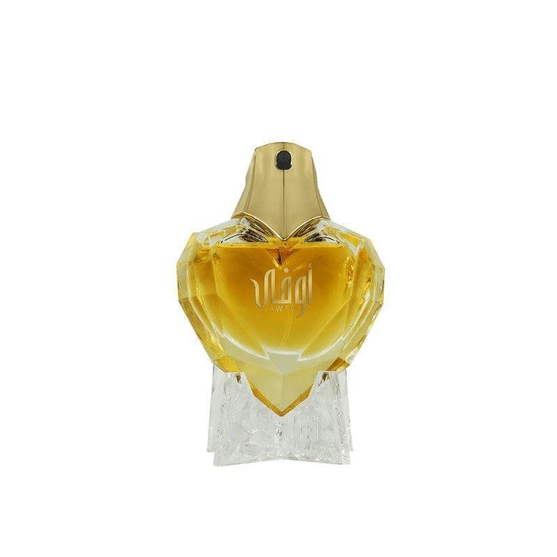 Crystal heart-shaped Middle Eastern perfume bottle with gold cap and amber fragrance
