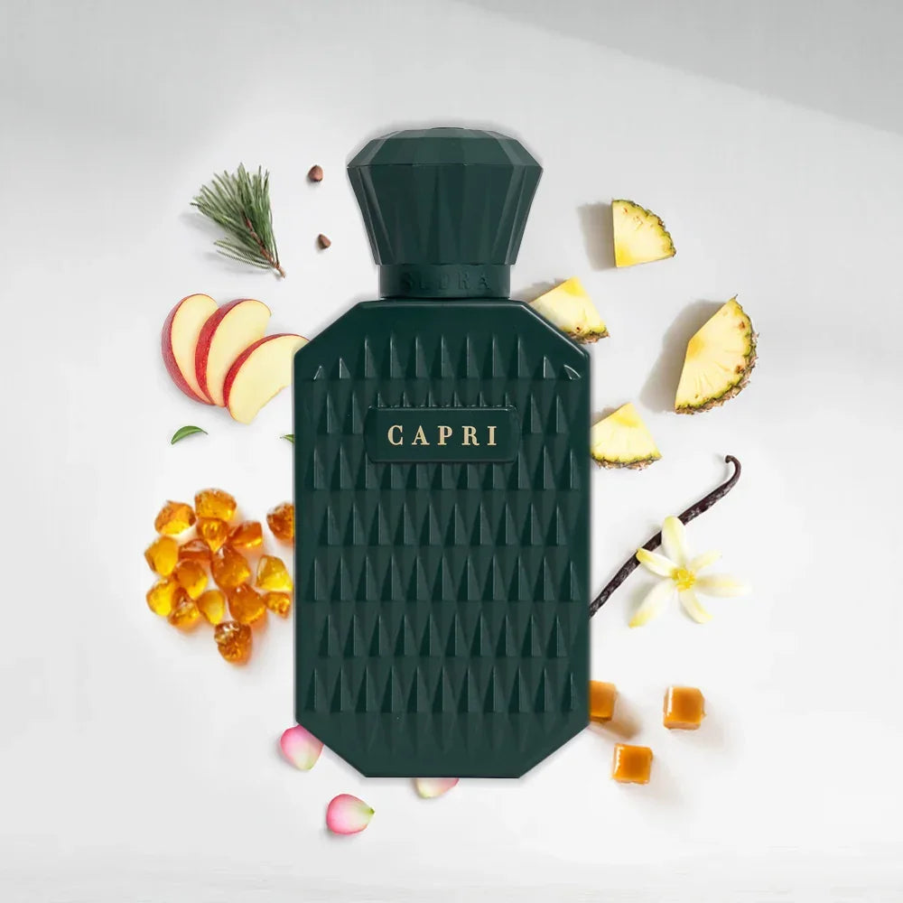 Capri perfume bottle with textured dark green design, surrounded by apple, pineapple, vanilla, caramel, and amber ingredients.