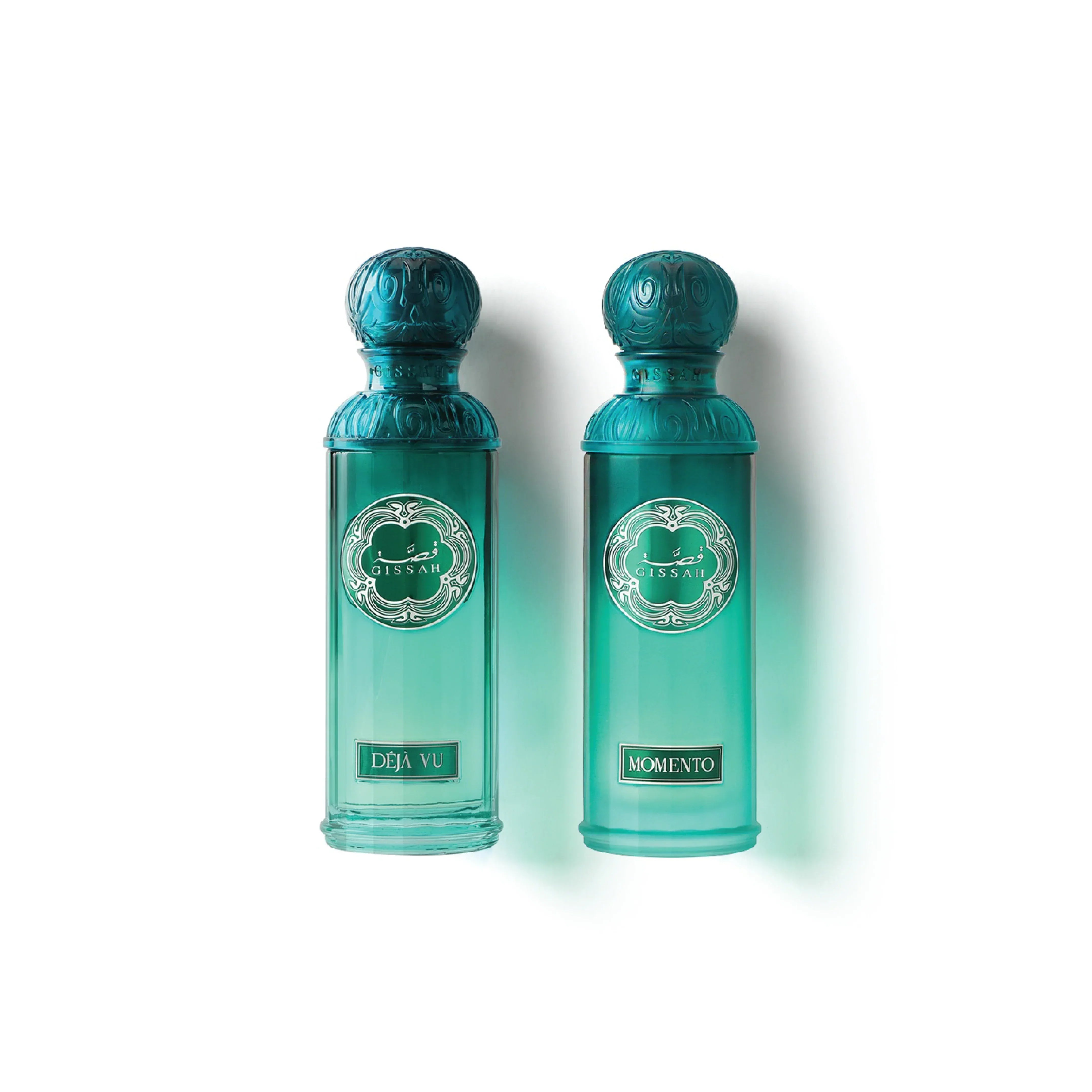 Two elegant green perfume bottles labeled Deja Vu and Momento with ornate caps.