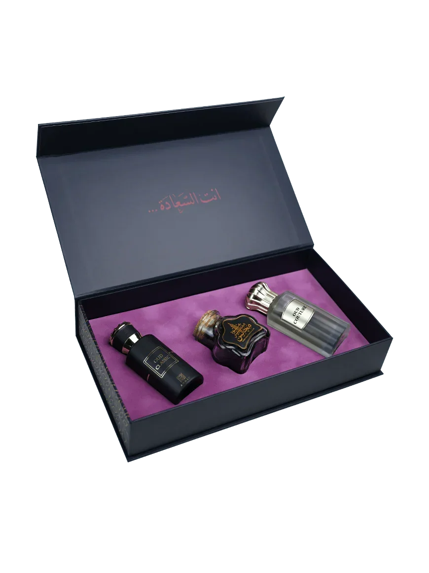 Luxury Middle Eastern perfume gift set with three elegant fragrance bottles in a purple-lined box