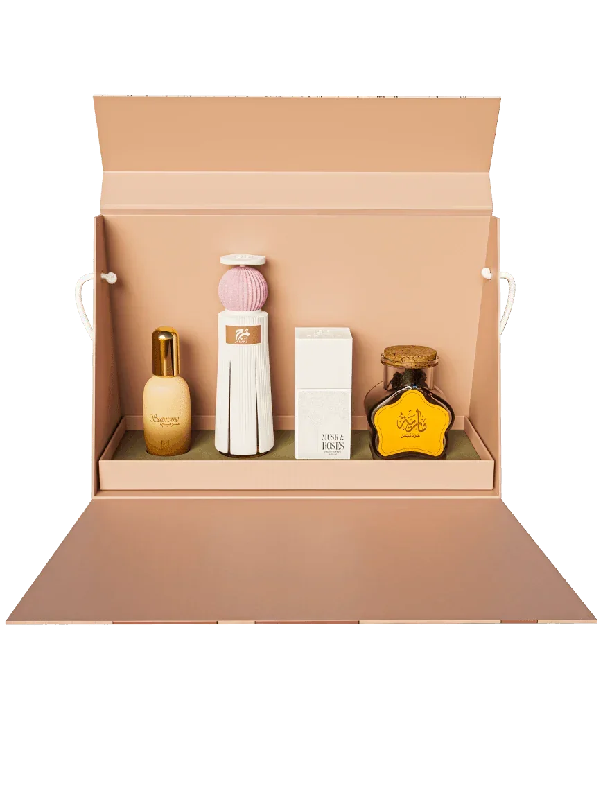 Luxury Middle Eastern perfume gift set with elegant bottles in an open blush box
