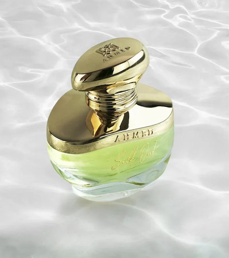 Luxury green perfume bottle with gold cap, elegant design for lasting scent allure