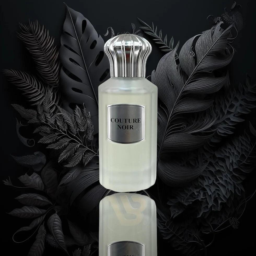 Couture Noir luxury perfume bottle with elegant silver cap, surrounded by dark botanical leaves