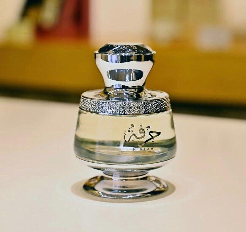 Elegant Middle Eastern perfume bottle with intricate silver detailing and Arabic script, showcasing luxury fragrance.
