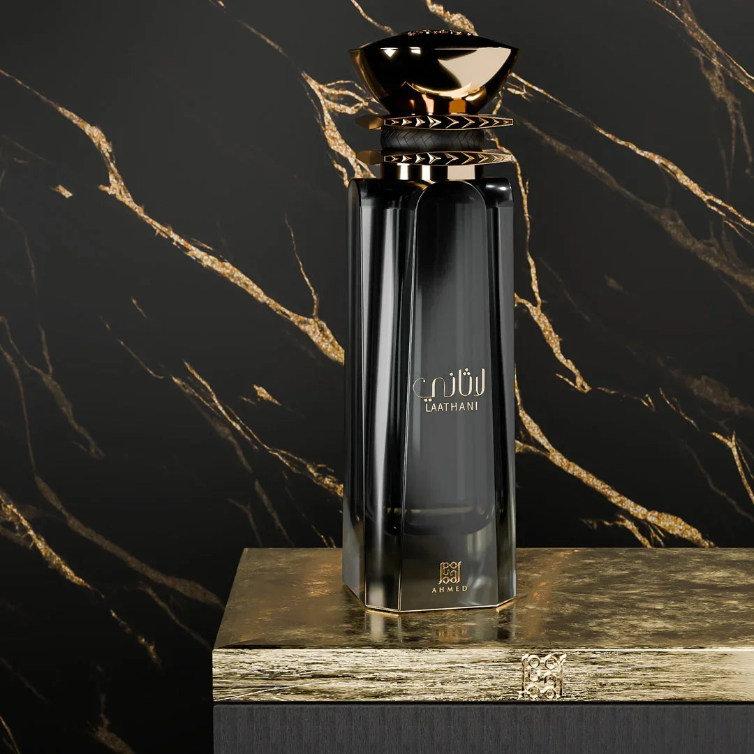 Elegant black and gold luxury perfume bottle with Arabic script, set against a marble background.