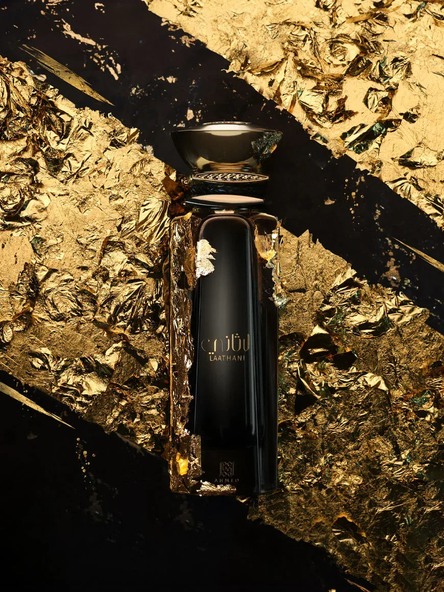 Luxurious black and gold Middle Eastern perfume bottle on gold foil background