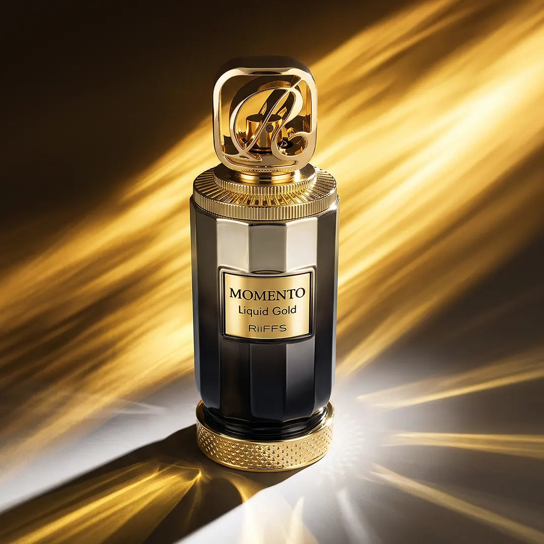 Momento Liquid Gold 100ml perfume bottle in black glass with gold accents and a decorative cap against a golden light background.