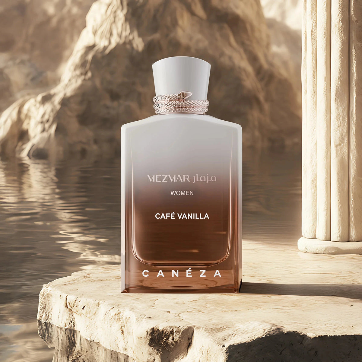 Canéza Mezmar Jolie Women Café Vanilla perfume bottle standing on a stone platform next to a classical column, with a warm, rocky background and water reflection.