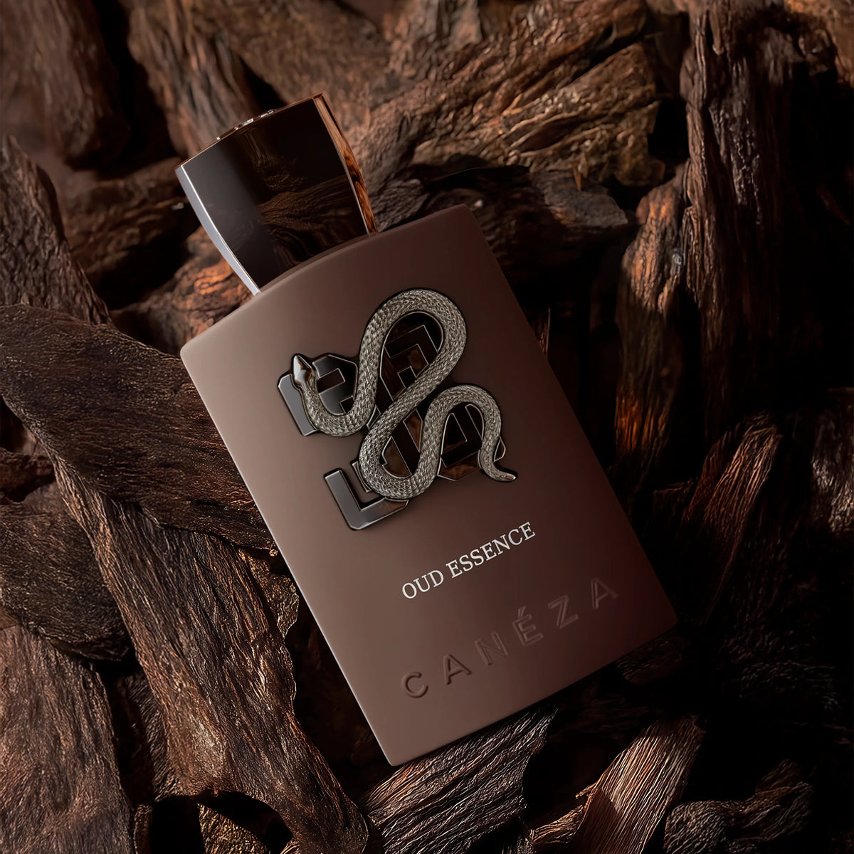 Brown perfume bottle with snake design on a wooden background
