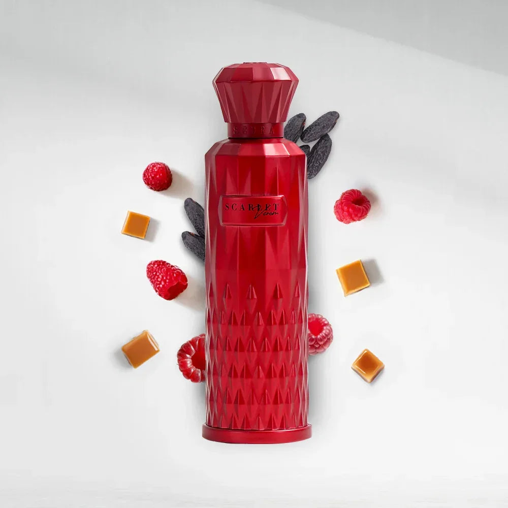 Red diamond-textured perfume bottle with raspberries, caramel cubes, and tonka beans on white background