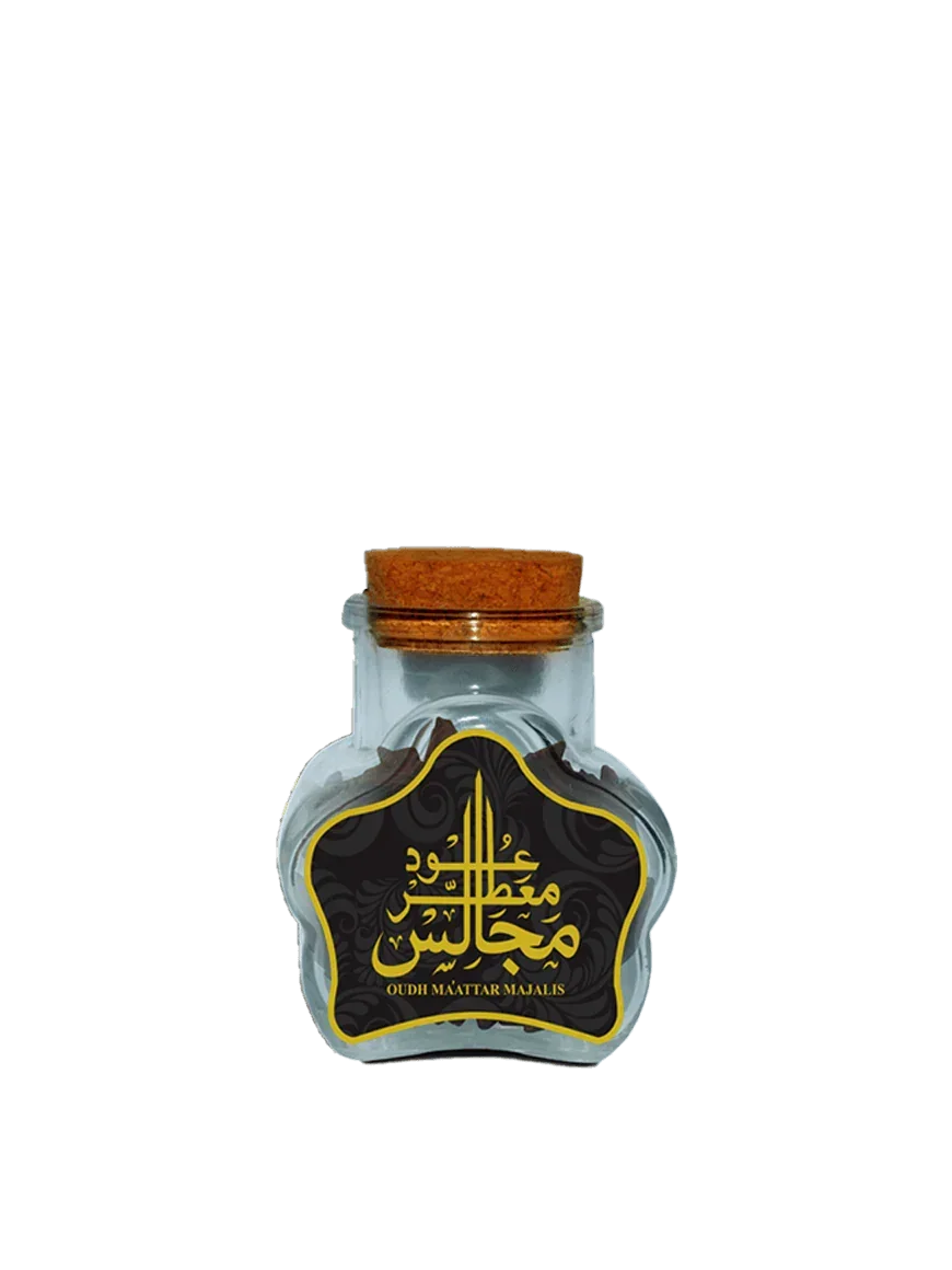 Glass jar of Oudh Maattar Majalis, Middle Eastern incense with Arabic text and cork lid.