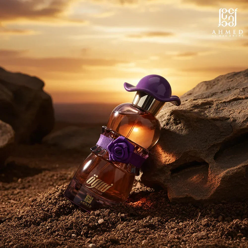 Elegant Middle Eastern perfume bottle with purple cap and rose detail set on desert sand at sunset