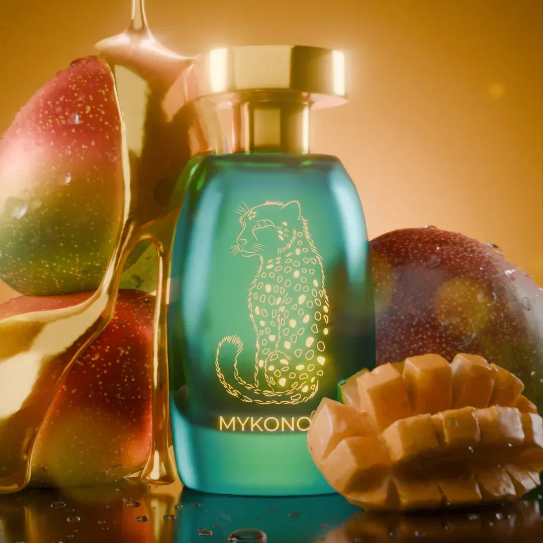 Luxury Mykonos perfume bottle with cheetah design, fresh mangoes, and golden honey backdrop