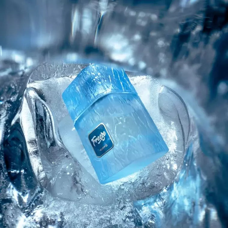 Riiffs Freeze 100ml perfume bottle with a textured blue glass design, nestled inside a block of melting clear ice.