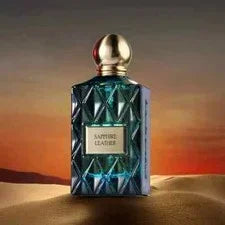Sapphire Leather luxury perfume bottle on sand with sunset desert background